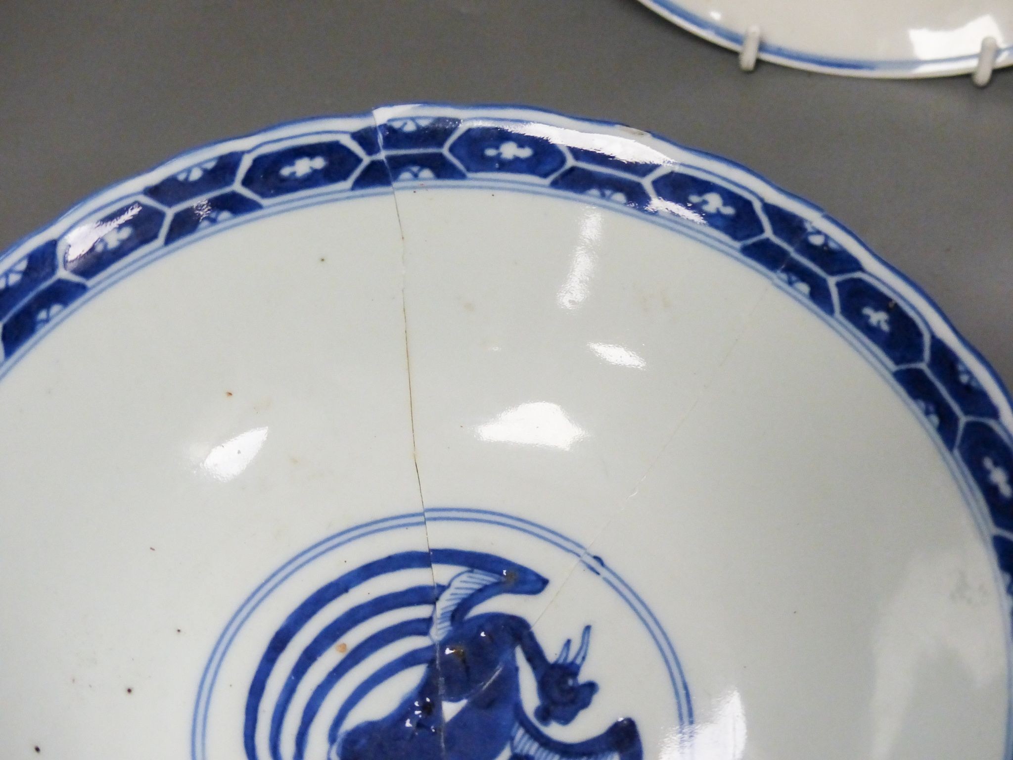 A Chinese blue and white landscape bowl, a/f and a Chinese blue and white ‘dragon’ dish, 18 and 16.5 cm